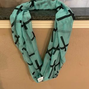 This is a teal and black Paul smith scarf it has lovely crosses all over it.